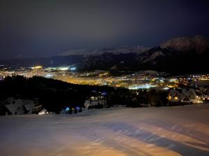 a view of a town in the snow at night at Willa Irena in Kościelisko