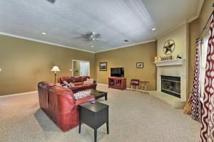 a living room with a couch and a fireplace at Cozy College Station Home with Patio and Fireplace in College Station