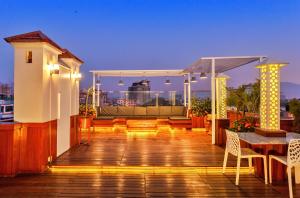 a deck with a table and chairs on a building at Feel Like Home Nepal in Kathmandu