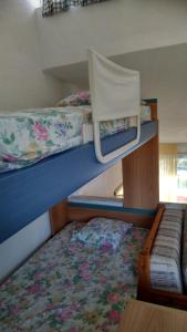 a room with two bunk beds and a table at 2-bed maisonette in pine forest, 250m from beach between Skala Fourka and Siviri in Skála Foúrkas