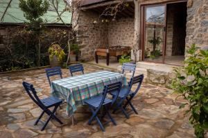a table and chairs in a patio with a piano at Casa Rural Castil de Cabras in San Miguel de Valero +19 photos