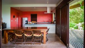 a dining room with a wooden table and chairs at Koh Yao Sunrise Villa in Ko Yao Noi +46 photos
