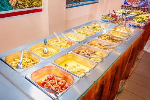 a buffet with many trays of food on a table at Los Portales de Chivay in Chivay
