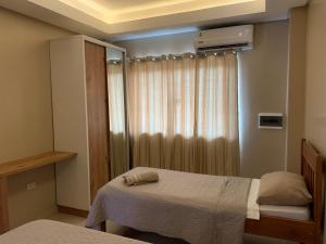 מיטה או מיטות בחדר ב-NatuCenter Hospedaje