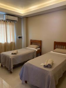 מיטה או מיטות בחדר ב-NatuCenter Hospedaje