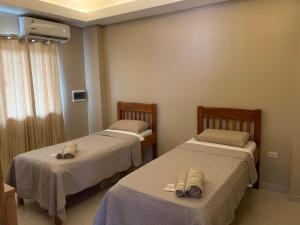 מיטה או מיטות בחדר ב-NatuCenter Hospedaje