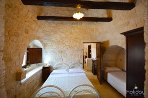 Posteľ alebo postele v izbe v ubytovaní I Trulli Di Nonno Giovanni + 37 fotografií