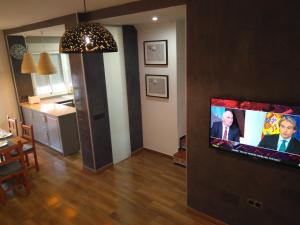 a living room with a flat screen tv on a wall at Alojamiento con piscina para grandes grupos in Chiclana de la Frontera