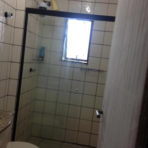 y baño con ducha, ventana y aseo. en jurere, en Florianópolis