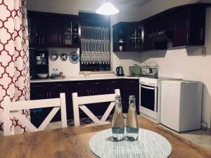 a kitchen with two bottles on a table at Apartament Pod Skarpą z balią Wieżyca in Szymbark