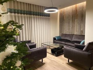 a living room with a christmas tree and a couch at Hotel Beau Site in Francorchamps