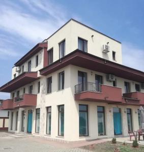 a large white building with a red roof at Stella Maris in Techirghiol