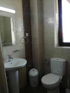 a bathroom with a white toilet and a sink at Stella Maris in Techirghiol