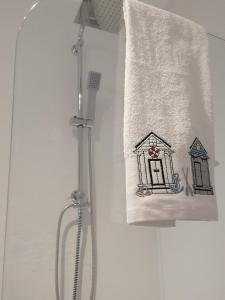 a towel with a picture of a house on it at Coastal Escape Sandgate in Folkestone