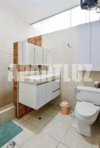 a bathroom with a toilet and a sink at Apartment Acogedor in Huanchaco