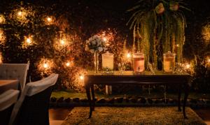 a table with candles on it with lights at Casa Lolita Hotel-Boutique in Portoviejo