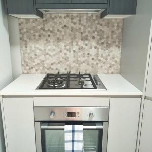 a stove top oven in a small kitchen at Ashley's Retreat Umina Beach in Umina