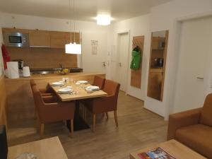 a kitchen and dining room with a table and chairs at Enjoy Ferienwohnung Feldberg Grafenmatt in Feldberg