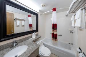 a bathroom with a sink and a toilet and a tub at Red Roof Inn Lumberton in Lumberton +22 photos