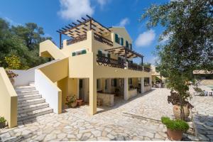 a house with a staircase in front of it at Villa Elaia Suites & Apartments No.7 in Gaios