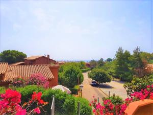 a view of a garden with flowers and a street at Casa al mare Costa Rei - Piscina Rei in Costa Rei