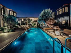 a swimming pool in front of a house at night at Bernadet Alaçatı in Alaçatı