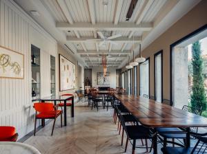a long dining room with tables and chairs at Bernadet Alaçatı in Alaçatı