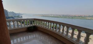 a balcony with a view of a river at Charming sunset,Panoramic Nile view & pyramid view in Cairo