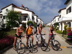 a group of three men riding bikes down a street at Antalya belek private villa private pool private beach 3 bedrooms close to land of legends in Belek