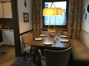a dining room table with chairs and a window at Apartment Vogelsinger in Ossiach