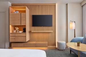 a hotel room with a bed and a television at Hotel AKA Brickell Miami in Miami