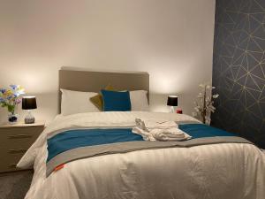 a bedroom with a large bed with blue and white at Heaton Park Road Professional Lets in Newcastle upon Tyne