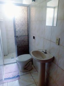 a bathroom with a toilet and a sink and a shower at Pousada Brasil - Self Check-in in Aparecida