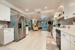 a kitchen with white cabinets and stainless steel appliances at #1 Island Hideaway PICK ME!!! in Fort Myers Beach