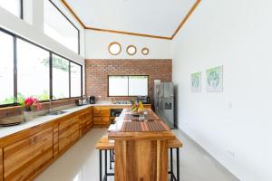 a kitchen with a wooden table in the middle at Villa Koi ~ Brand NEW Villa ~ 2 Bedrooms with Pool in Carmen