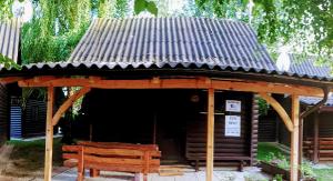 a wooden pavilion with a bench in front of it at KRESNIČKA in Čatež ob Savi