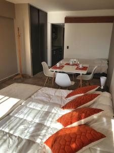 a large bed in a room with a table and chairs at Bariloche View Apartment in San Carlos de Bariloche