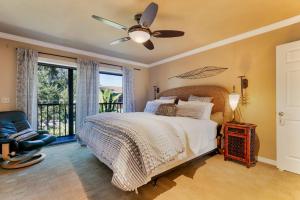 a bedroom with a bed with a ceiling fan and a window at #1 Island Hideaway in Fort Myers Beach