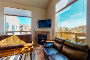 a living room with a couch and a fireplace at Rim Vista 11A2 in Moab