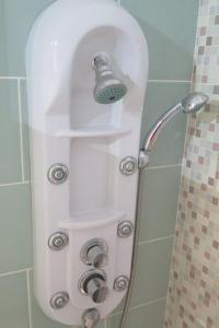 a shower with a shower head and a bell at Marisol 2F Waterfront in Armação de Pêra +19 photos