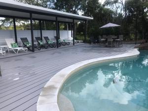 a swimming pool on a deck next to a house at Clouds Montville in Montville