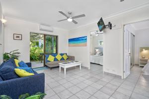 a living room with a couch and a table at Cairns Northern Beaches Holiday Retreat in Clifton Beach