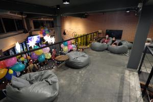 a group of bean bags in a room with people at BED STATION Hostel Ratchthewi in Bangkok