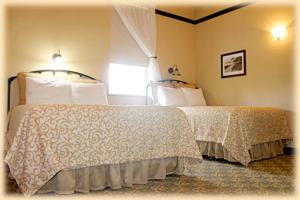 a bedroom with two beds and a window at Exit Glacier Lodge in Seward