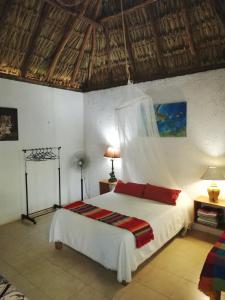 A bed or beds in a room at Mayan Bungalow Near Chichén