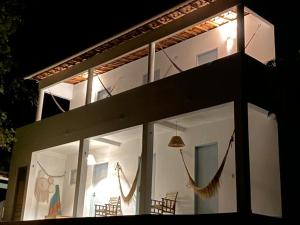 a house with windows and chairs in front of it at CasaMar Guriú in Guriú