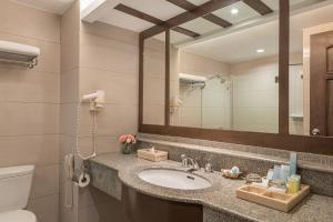 a bathroom with a sink and a mirror at Henann Regency Resort and Spa in Boracay