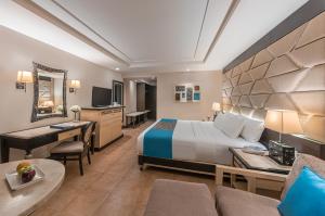 a hotel room with a bed and a desk at Henann Regency Resort and Spa in Boracay