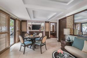 a living room with a table and chairs at Henann Regency Resort and Spa in Boracay