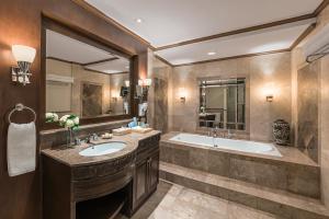 a bathroom with two sinks and a tub at Henann Regency Resort and Spa in Boracay